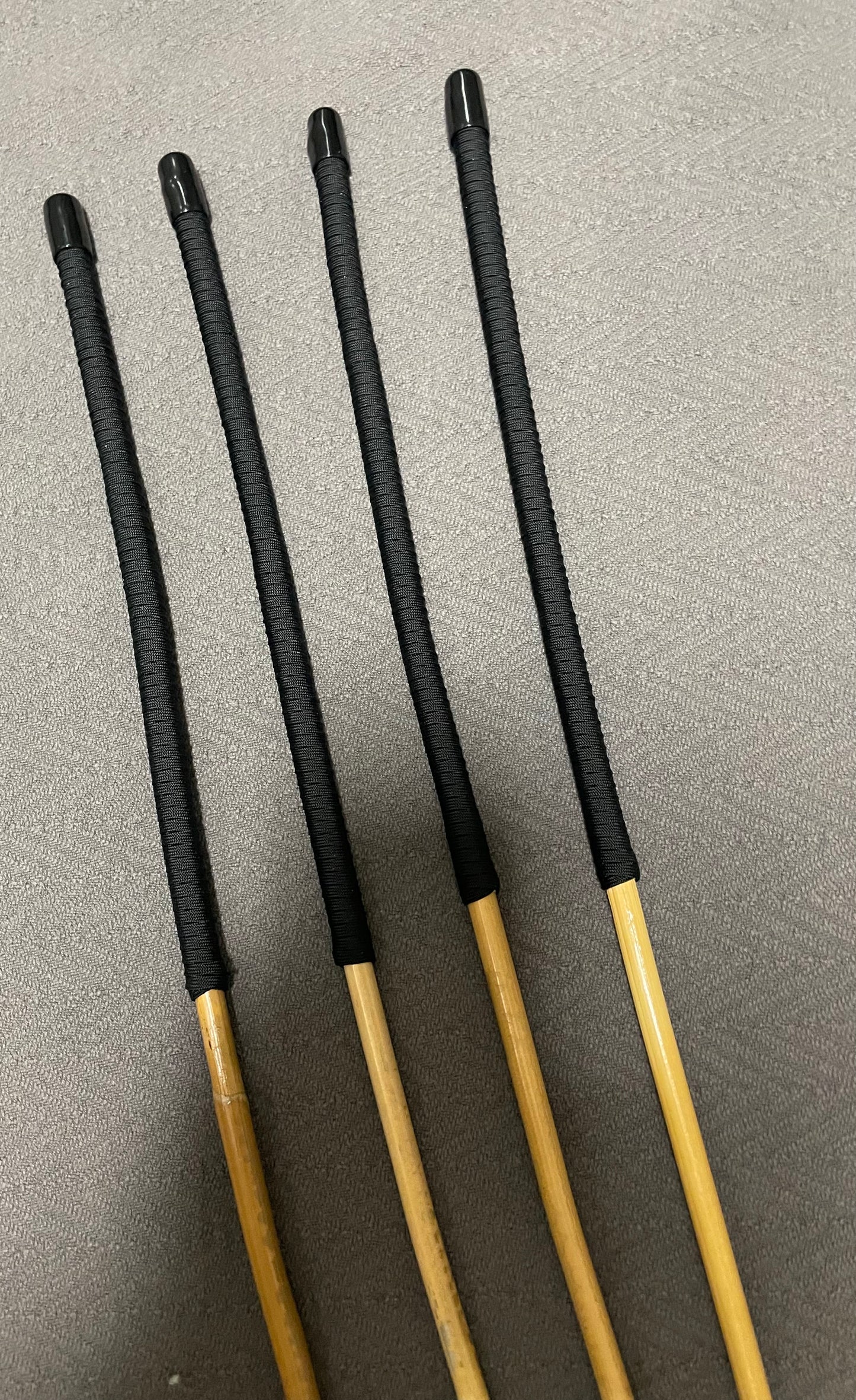 Set of 4 Senior Kooboo Rattan Punishment canes with Black Paracord Handles - 83 to 87 cms L & 9.5 - 10.5 mm D - Englishvice Canes