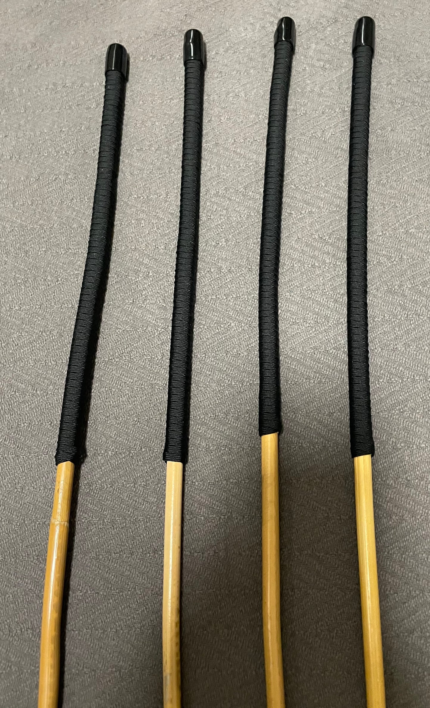 Set of 4 Senior Kooboo Rattan Punishment canes with Black Paracord Handles - 83 to 87 cms L & 9.5 - 10.5 mm D - Englishvice Canes