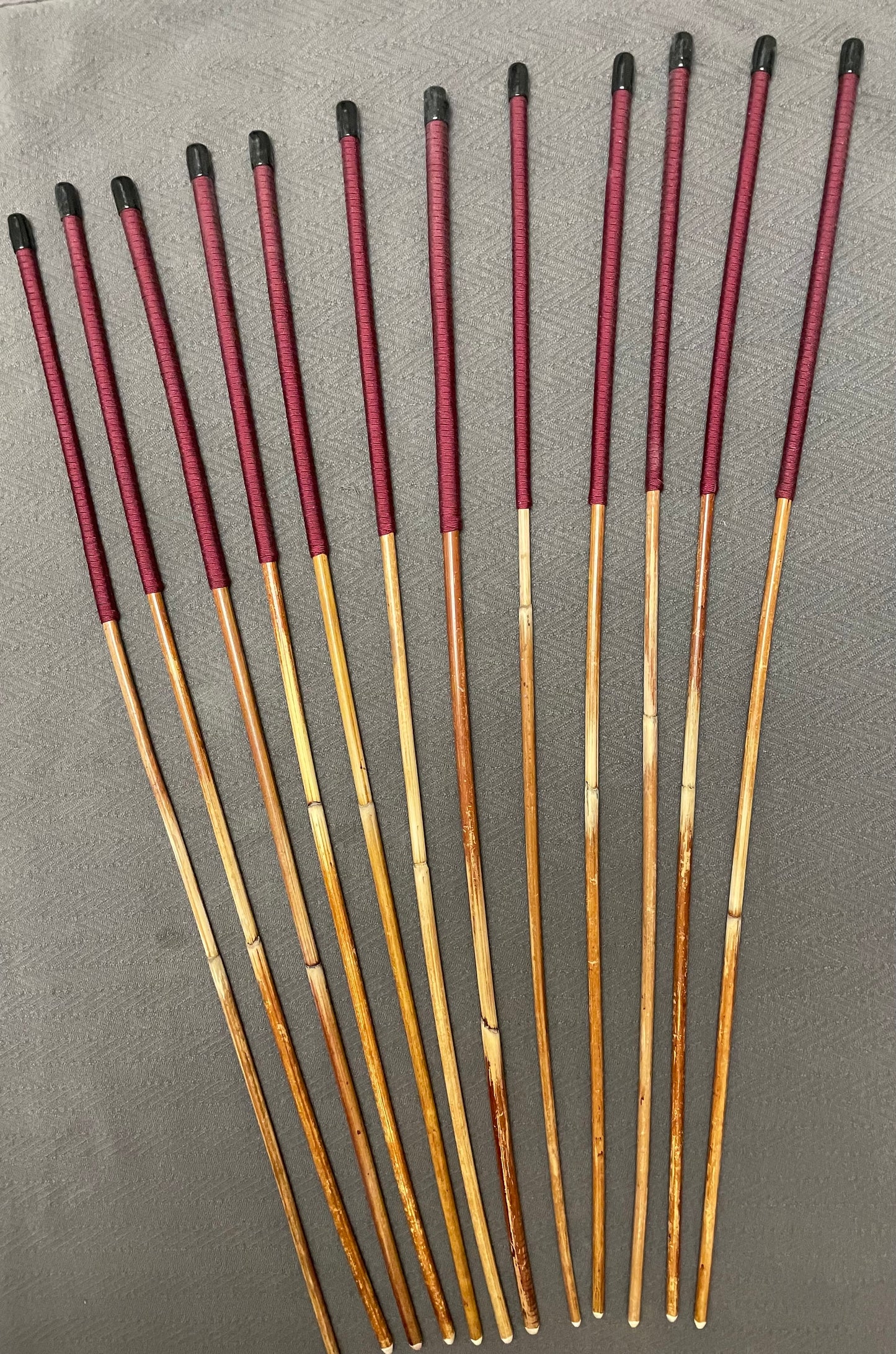 Set of 12 Classic Dragon Rattan Punishment Canes with Burgundy Paracord Handles - 95 to 100 cms Length - Sales Special