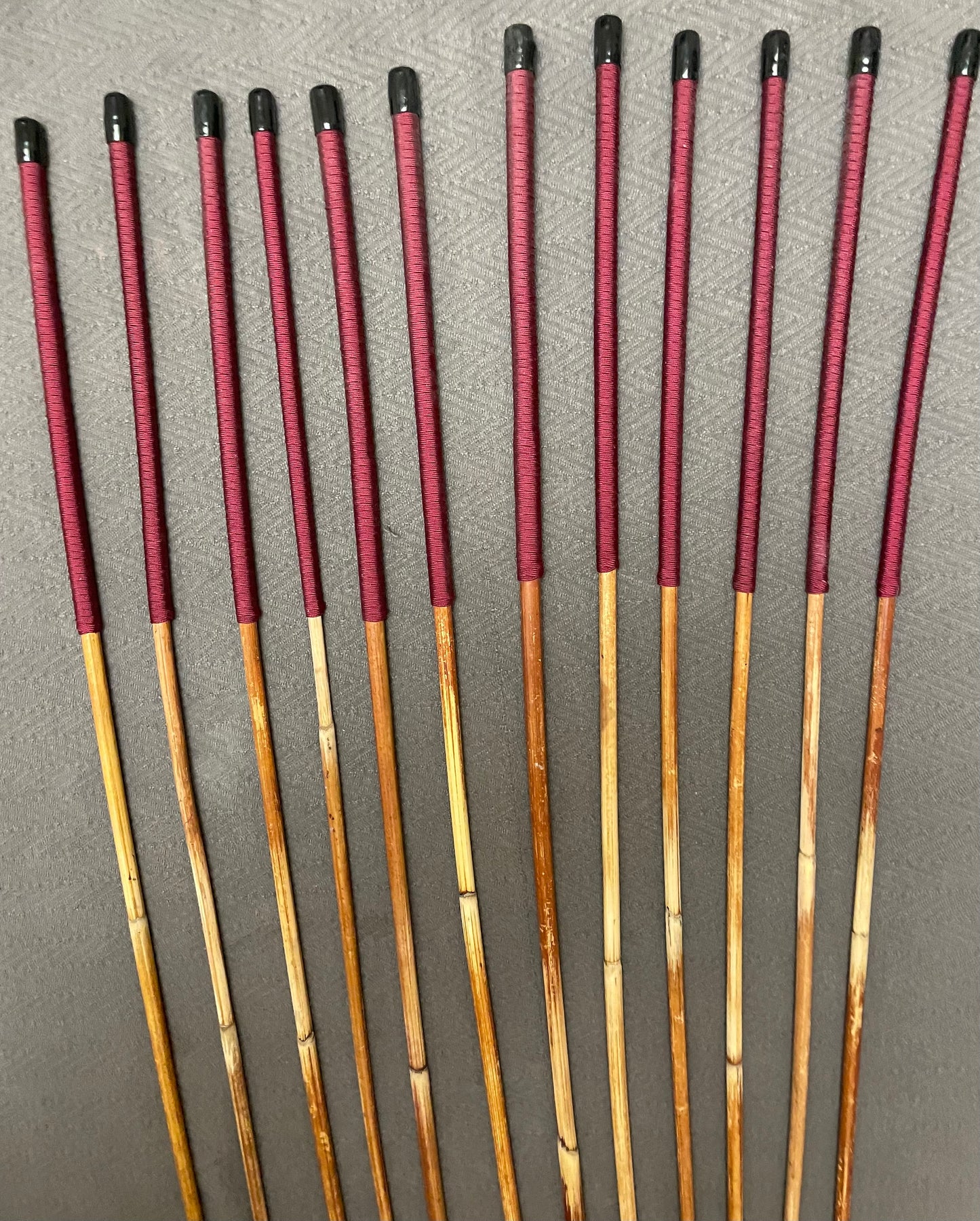 Set of 12 Classic Dragon Rattan Punishment Canes with Burgundy Paracord Handles - 95 to 100 cms Length - Sales Special